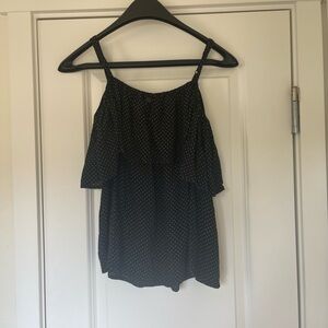 Black and white polka dot blouse with ruffle straps and a button down back.